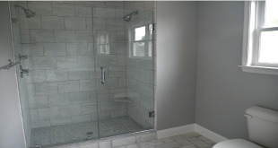 bathroom remodeling project with walk-in shower, fixtures, vanity and window